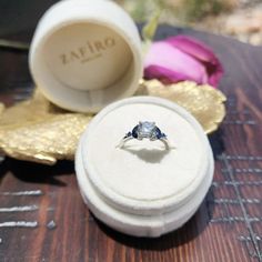 an engagement ring sits in a box on a table