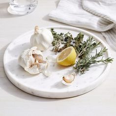 garlic, lemon and herbs on a marble plate