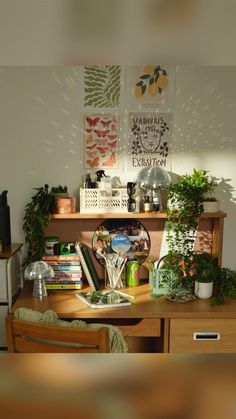 a wooden desk topped with lots of books and plants