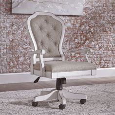 a white desk chair sitting on top of a carpeted floor next to a brick wall