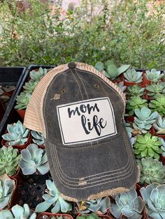 Details Vintage Distressed Trucker Cap "Mom Life"Color: Black Distressed Material: Cotton/Polyester blend, Mesh backSize: One size fits most, with an adjustable snapback strap. Unisex cap. Adjustable Distressed Trucker Baseball Cap, Adjustable Distressed Trucker Hat Baseball Cap, Casual Letter Print Baseball Cap For Mother's Day, Casual Trucker Hat With Letter Print For Mother's Day, Distressed Snapback Baseball Cap, Distressed Snapback Baseball Hat, Distressed Adjustable Trucker Hat For Outdoor, Distressed Adjustable Snapback Baseball Hat, Distressed Adjustable Snapback Baseball Cap