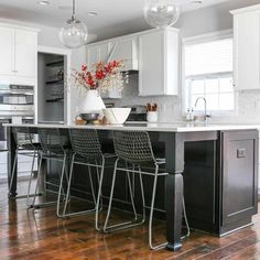 Adding an industrial quality, like these metal counter stools, to a kitchen design transforms a homey kitchen into a more eccentric space. Enhance the custom qualities through small additions like Edison or exposed bulbs. The wooden island in this kitchen reflects gray undertones from the surroundings...   Image: salt_and_home