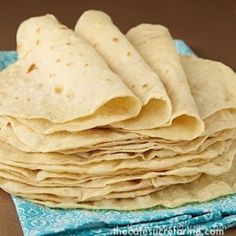 a stack of tortillas sitting on top of a blue napkin