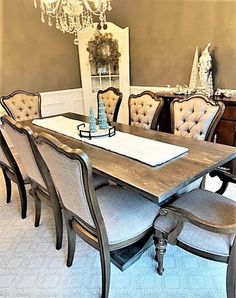 a dining room table with chairs and a chandelier