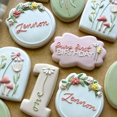 decorated cookies in the shape of flowers and numbers for a first - birthday party or special occasion