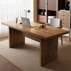 a wooden desk with a laptop on it in front of a closet full of drawers