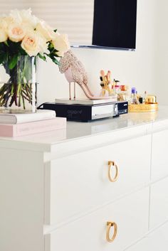 a white dresser topped with lots of drawers