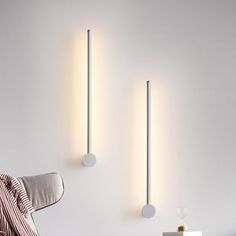 two lights that are on the side of a wall