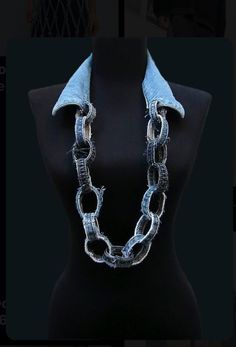 a black mannequin with silver chains on it