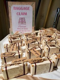 small packages of luggage claim sitting on a table next to a sign that says baggage claim