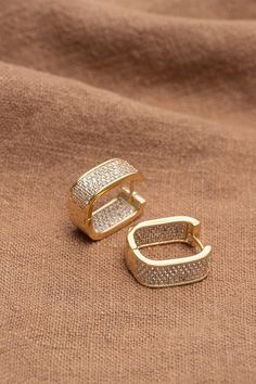 Elevate your look with these stunning Barbie Brides Huggie Earrings. The earrings feature exquisite micro pave cubic zirconia in a round shape set in 18K gold-plated copper. The clip-on closure makes them easy to wear and suitable for any occasion, be it an engagement, wedding, graduation, birthday, Christmas or Valentine's Day gift. The beauty of these earrings lies in their excellent cut grade and silver-colored main stone color, which reflects light beautifully. The huggie hoop style with a pavé setting adds a touch of glamour and sophistication. These earrings are also nickel-free, making them safe for those with sensitive ears. Add a touch of beauty to any outfit with these gorgeous earrings. Gold Huggie Diamond Earrings With Pave Setting, Luxury Gold Cubic Zirconia Huggie Earrings, Luxury Gold Hoop Earrings With Pave Setting, Gold Cubic Zirconia Diamond Earrings With Sparkling Stones, Barbie Bride, Women Earrings, Pave Setting, Huggie Earrings, Micro Pave