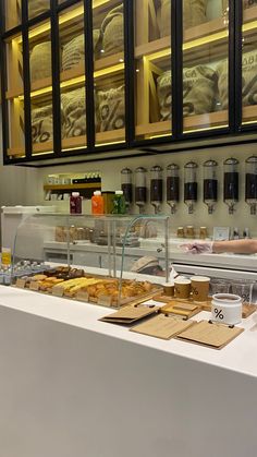 a counter with donuts and other pastries on it in a store or restaurant