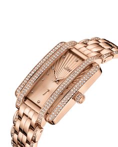 Understated glamour served with a twist. Mink stands out with a 28 MM rectangular case, crystal-embellished lugs, and 12 diamonds marking the hours on the fan-textured dial. Crafted in 18K rose gold-plated stainless steel, the multi link bracelet is framed with crystals and finished with a hidden clasp. Elegant Rectangular Rose Gold Diamond Watch, Elegant Rose Gold Rectangular Diamond Watch, Luxury Rose Gold Diamond Watch With Rectangular Dial, Luxury Diamond Watch With Rectangular Dial For Evening, Elegant Rose Gold Diamond Watch For Evening, Luxury Diamond Watch With Metal Dial For Evening, Rose Gold Rectangular Dial Watch For Evening, Luxury Rose Gold Diamond Watch With Metal Dial, Gold Diamond Watches