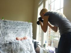 a woman taking a photo of a baby