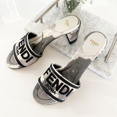 This Is An Authentic Pair Of Fendi Canvas Logo Tie-Dye Sandals Size 36 In Black And White. 2.75-Inch Heel Covered Heel. Gifted But A Bit Too Small For Me. Authentic, Brand New Never Worn. Unfortunately No Dust Bag Or Box. Designer White Flat Heels, Designer Flat Heels For Summer, Designer White Summer Heels, Luxury Summer Slip-on Heels, Fendi Slippers, Fendi Canvas Sandals, Fendi Blue Shoes, Fendi First Heels, Fendi Sandals