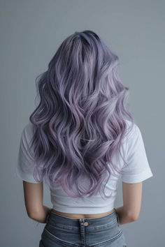 Long wavy lavender grey hair with a unique and stylish appearance. Light Violet Hair Color, Periwinkle And Blonde Hair, Metallic Lavender Hair, Grey Hair With Purple, Hair Colour Ideas For Greying Hair, Violet Grey Hair, Lavender Brunette Hair, Silver And Lavender Hair, Gray Hair Natural