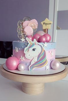 a birthday cake decorated with pink and blue decorations