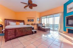 a bedroom with a large bed sitting next to a tv on top of a wooden dresser