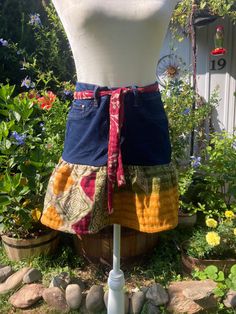 a mannequin wearing a skirt made out of old jeans and other fabric material