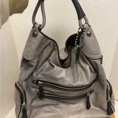 Coach Leather Hobo Bag In Gray With Purple Lining. Small Stain On Front And Back Of Bag. Gray Hobo Shoulder Bag, Gray Hobo Bag For Daily Use, Gray Satchel With Removable Pouch And Double Handle, Gray Hobo Shoulder Bag With Removable Pouch, Gray Hobo Bag With Removable Pouch, Gray Leather Shoulder Bag With Silver-tone Hardware, Gray Leather Handled Satchel Shoulder Bag, Gray Tote Bag With Zipper Closure, Gray Hobo Shoulder Bag For Shopping