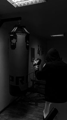 a person sitting in a chair near a punching bag