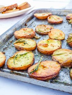 baked potatoes with herbs on a baking sheet