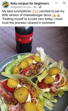 two lettuce wraps filled with meat and veggies next to a bottle of soda