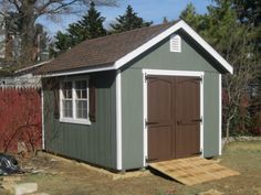 a small shed sitting in the middle of a yard