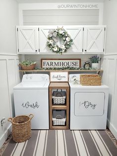 a white washer and dryer sitting in a laundry room next to a wreath