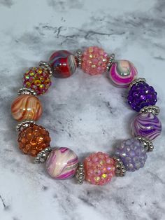 This colorful, chunky stretch bracelet is the perfect colorful accessory!   It's made with beautiful swirl, multicolored 10 mm acrylic bauble beads & rhinestone beads with silver spacers. It sparkles ✨ & shines beautifully!   It measures 7 inches in length on 100% polyester stretch cord, not wire.   It's the perfect statement bracelet that will get you lots of attention! Colorful Bracelet, Jewelry Colorful, Chunky Bracelet, Colorful Accessories, Chunky Bracelets, Colorful Jewelry, Rhinestone Bead, Statement Bracelet, Colorful Bracelets