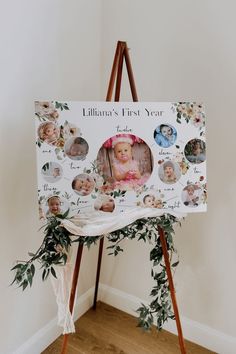 a baby's first year photo frame on an easel with greenery around it