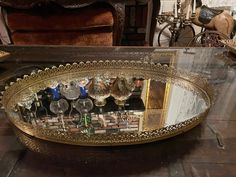 a large metal tray filled with lots of wine glasses on top of a wooden table