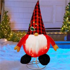 an outdoor christmas decoration featuring a gnome