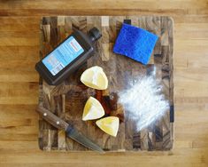 a cutting board topped with sliced lemons next to a knife