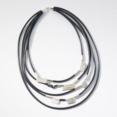 Silver Necklace - A bold multi-strand necklace is crafted from hand-textured sterling silver shapes on sleek black rubber tubing. Magnetic clasp. Modern Multi-strand Silver Jewelry, Modern Silver Multi-strand Jewelry, Modern Multi-strand Silver Necklace, Rubber Necklace, Artful Home, Multi Strand Necklace, Magnetic Clasp, Strand Necklace, Black Rubber