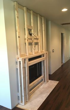 a living room with a fire place built into the wall and wood framing around it