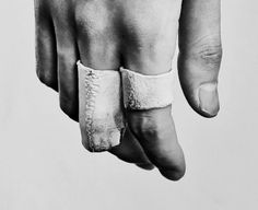 a man's hand with a band around it and his fingers wrapped in bandages