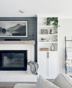 a living room filled with furniture and a fire place in front of a wall mounted tv