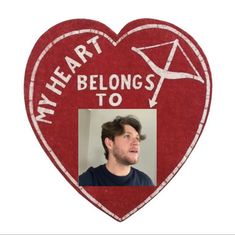 a red heart with a photo of a man in it