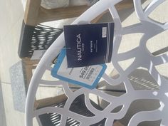 a blue and white credit card sitting on top of a metal table next to a chair