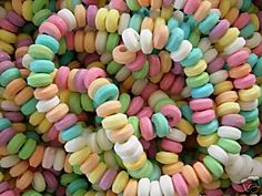 a pile of colorful candy sprinkles sitting on top of each other