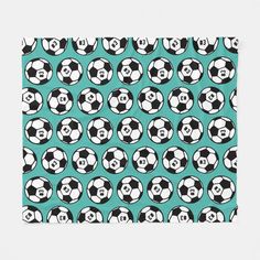 a blue and black soccer ball pattern on a teal background fleece throw blanket