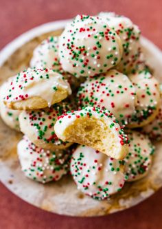 a white plate topped with cookies covered in sprinkles on top of a table