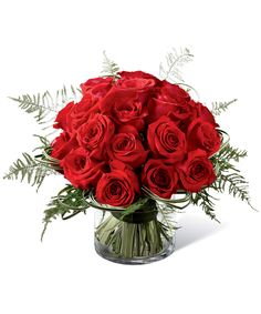 a bouquet of red roses in a glass vase