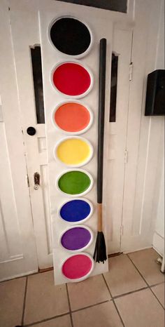 the paint pans are arranged in different colors on the wall next to the door