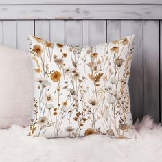 a white pillow sitting on top of a bed next to a furnishing covered headboard