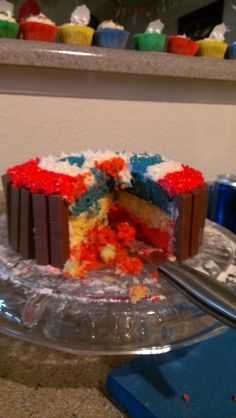 a piece of cake with red, white and blue frosting is on a clear plate