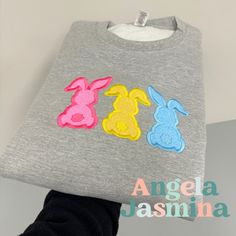 Hop into spring with our adorable Embroidered Easter Bunny Sweatshirt! Handcrafted with love and attention to detail, this cozy sweatshirt features a charming embroidered bunny design, perfect for celebrating the season in style. Made from soft, high-quality cotton blend material, our sweatshirt ensures both comfort and durability. The intricate embroidery adds a touch of whimsy, making it a delightful addition to your Easter wardrobe or a thoughtful gift for someone special. Whether you're atte Spring Embroidered Cotton Hoodie, Spring Crew Neck T-shirt With Machine Embroidery, Spring Crew Neck Tops With Bunny Design, Spring Crew Neck T-shirt With Butterfly Embroidery, Bunny Sweatshirt, Casual Crew Neck T-shirt With Bunny Design, Embroidered Bunny, Bride Sweatshirt, Bunny Design