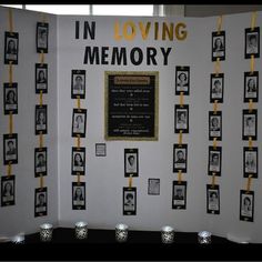 a memorial display with pictures and candles on the table in front of it that says in loving memory