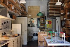 a room filled with lots of wooden shelves and drawers next to a white counter top